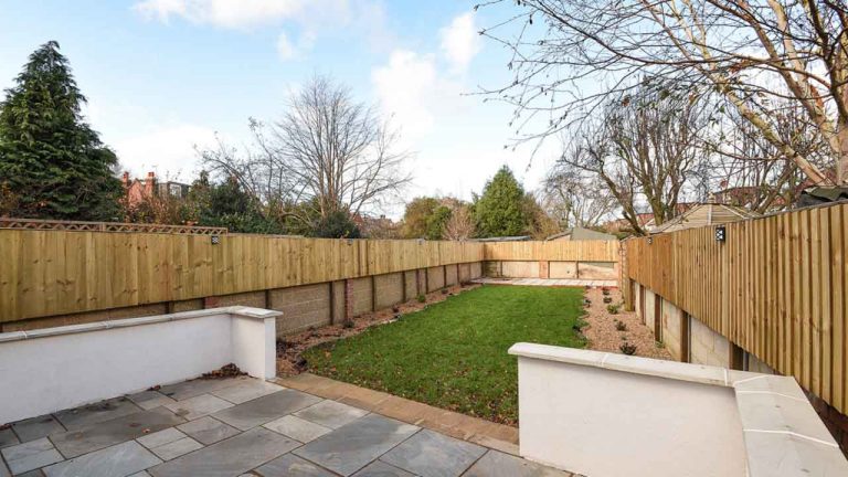Landscaped Garden Area with Slabs Leading Onto Natural Grass