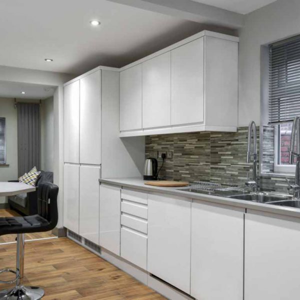 White Gloss Fitted Kitchen In Co-Living Housing Development